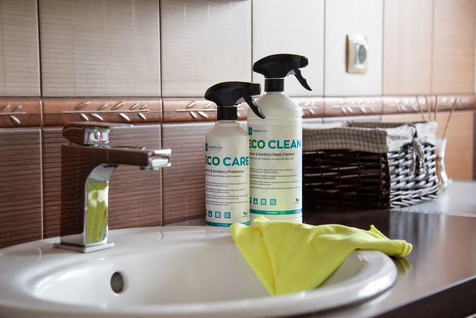 An adult male cleaning a glass window indoors, focusing on household chores and cleanliness.